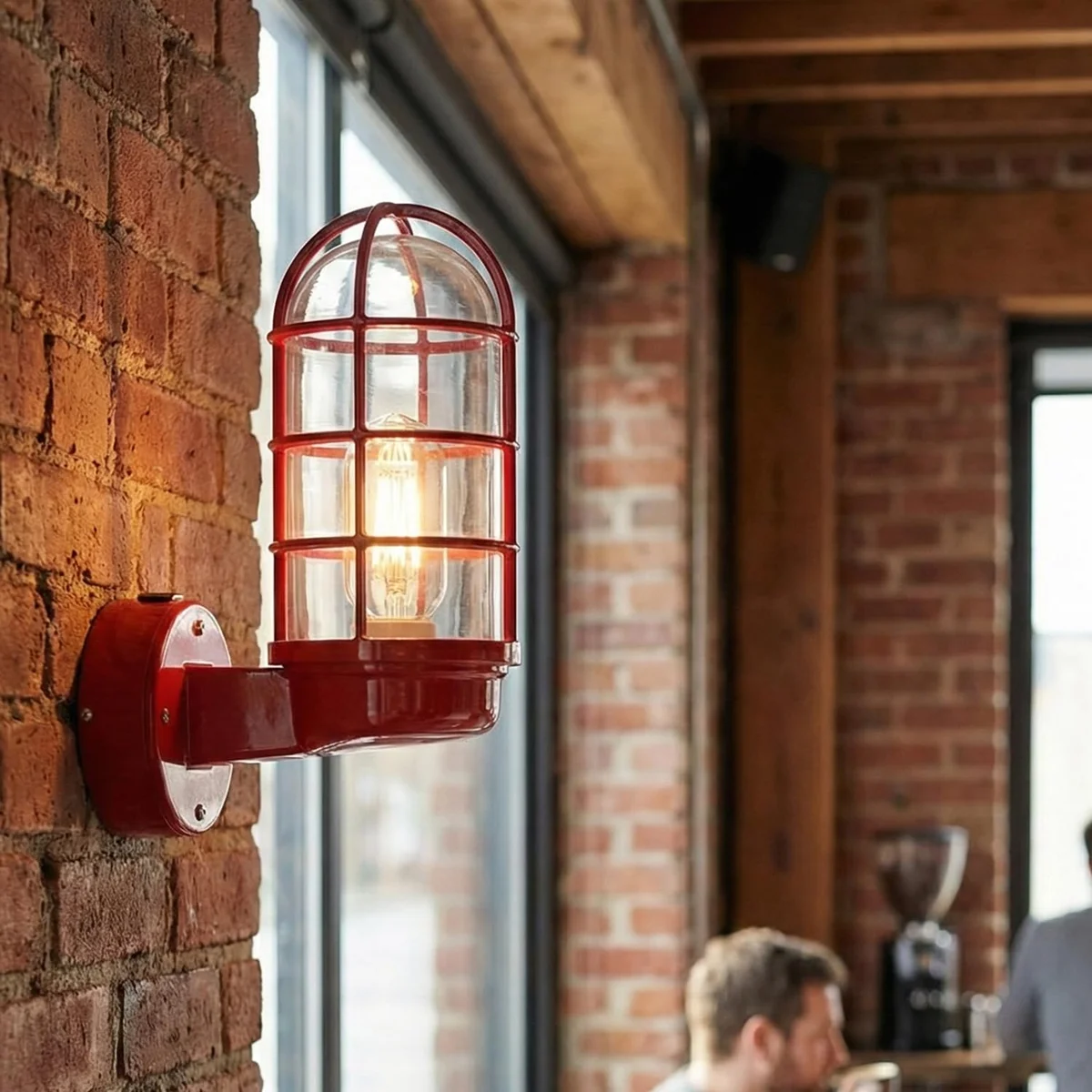 Compact wall sconce with metal frame and clear glass, vintage nautical conduit design for indoor wall mounting