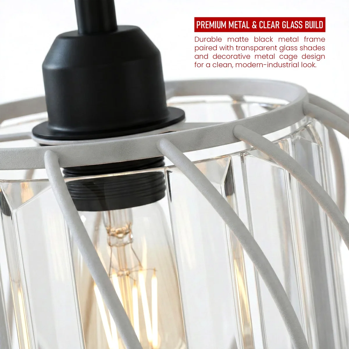 Three-light black metal pendant light with clear crystal shades hanging above a modern kitchen island