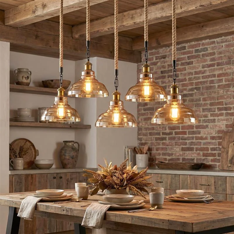 Vintage glass pendant lamp with iron fittings and hemp rope hanging from ceiling.
