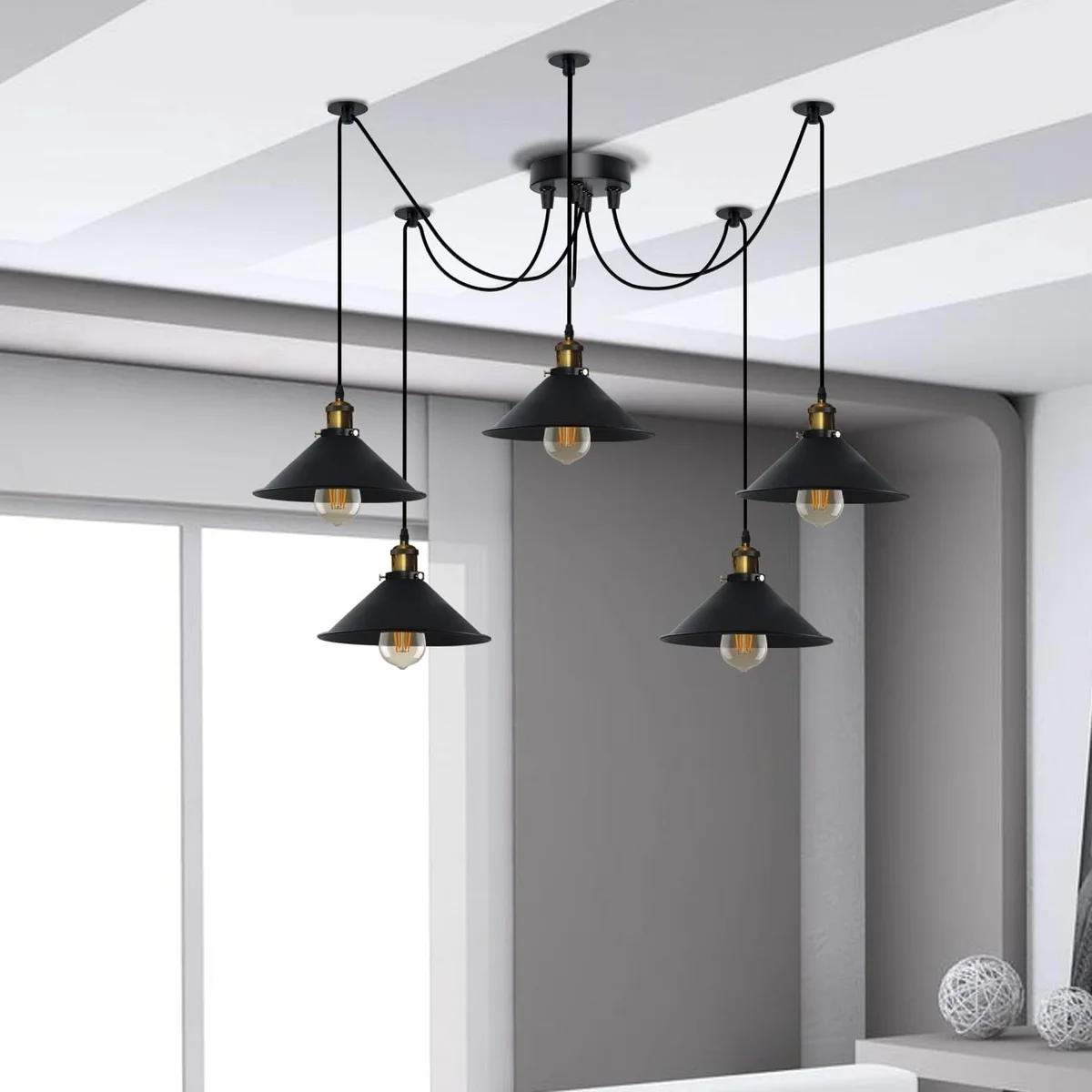 Black pendant light with five adjustable cone shades hanging from a single ceiling rose in industrial style