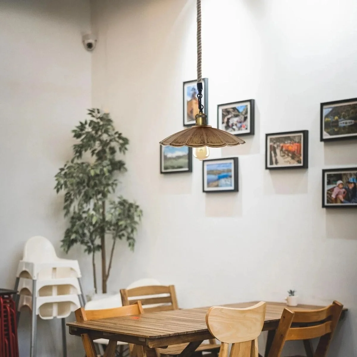 Vintage pendant light with scalloped metal shade and jute rope cord, ideal for rustic or industrial interiors