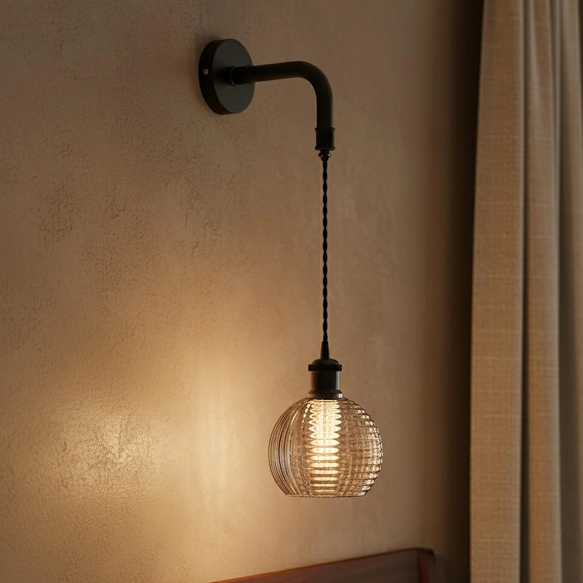 Modern industrial wall lamp with ribbed glass globe shade and adjustable pendant cord in matte black finish