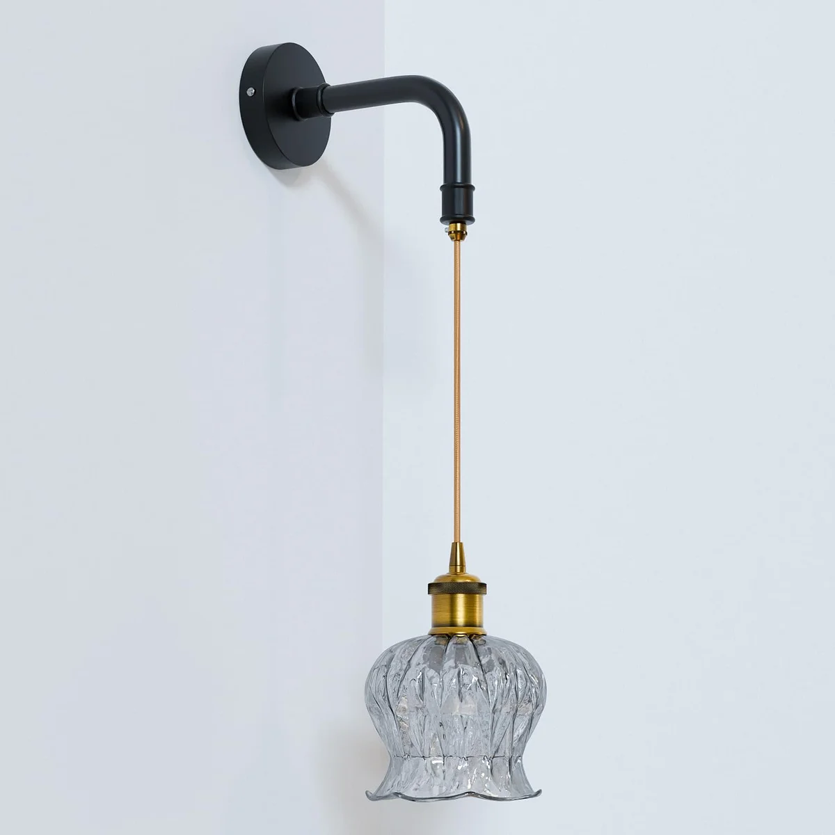 Modern industrial ribbed glass globe pendant light with matte black metal holder and twisted fabric cord hanging from ceiling