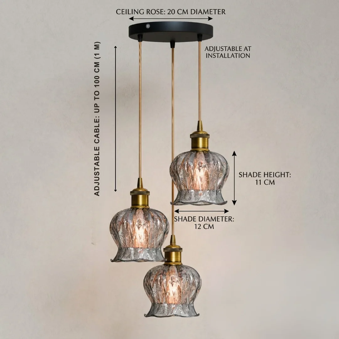 Matte black industrial pendant light with ribbed glass globe and adjustable cord pendant hanging against white background