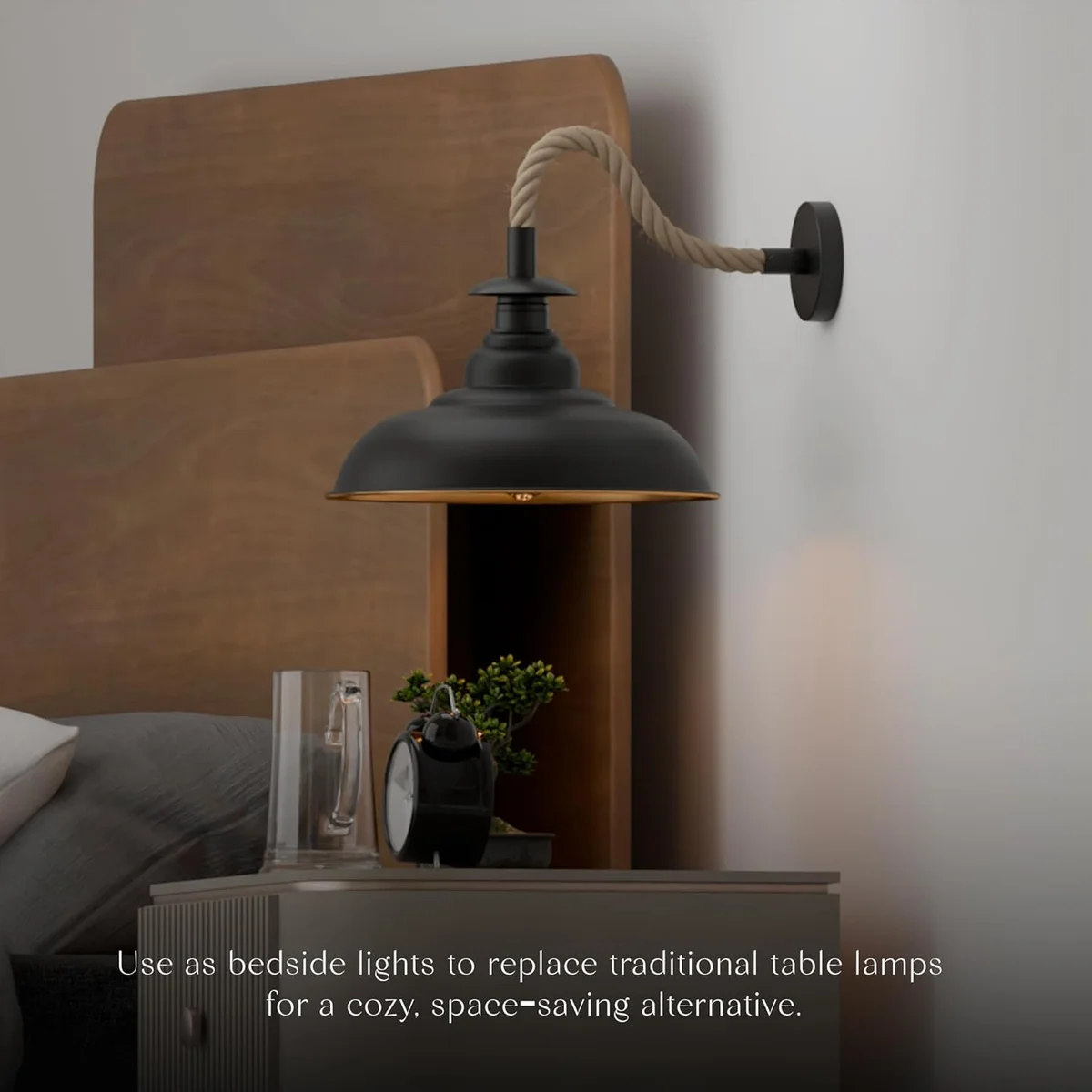 Black hemp rope wall light with 32cm curvy metal shade mounted on a white wall in an industrial vintage style room