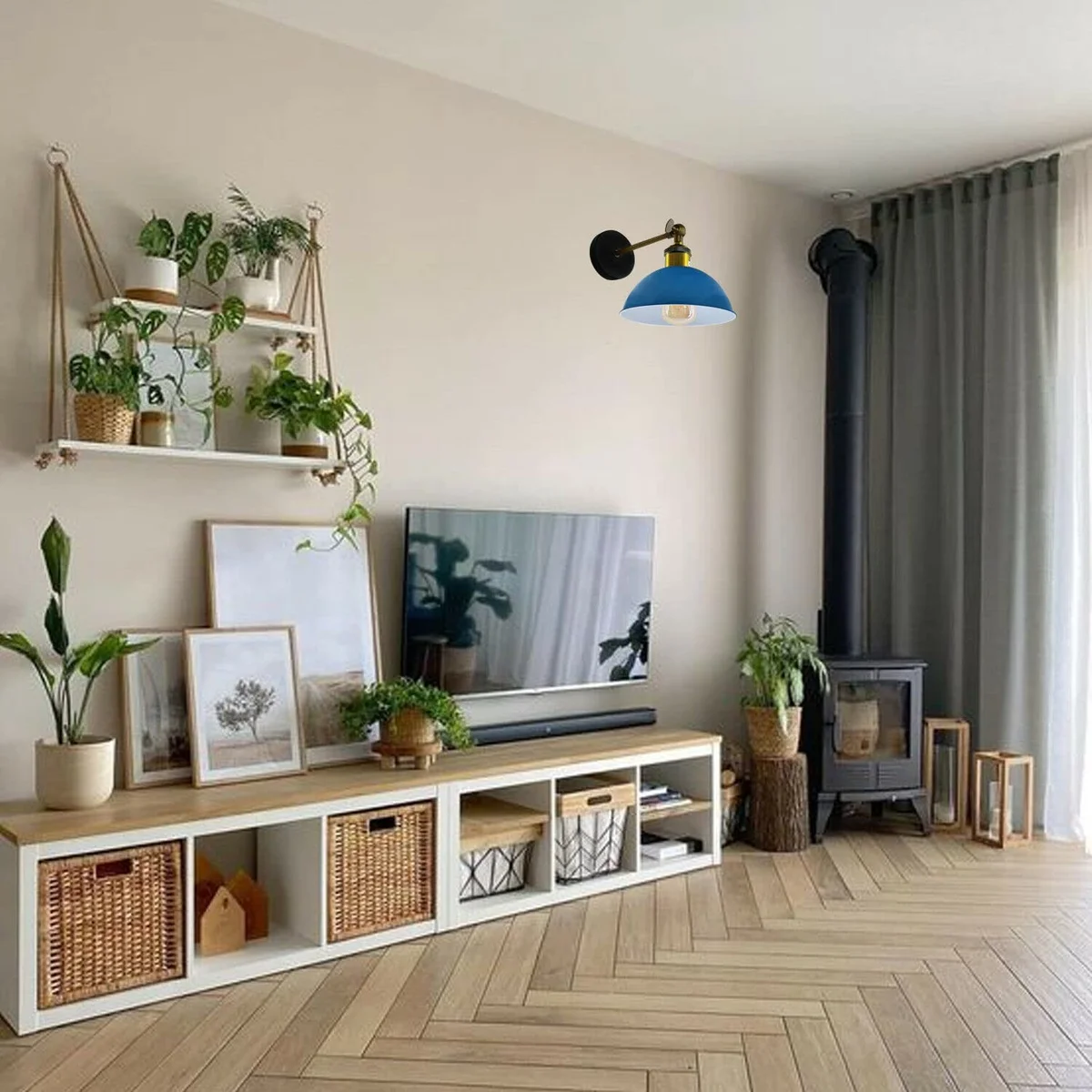 Vintage wall lamp with black metal cage and dome-shaped shade mounted on a white wall in farmhouse style decor