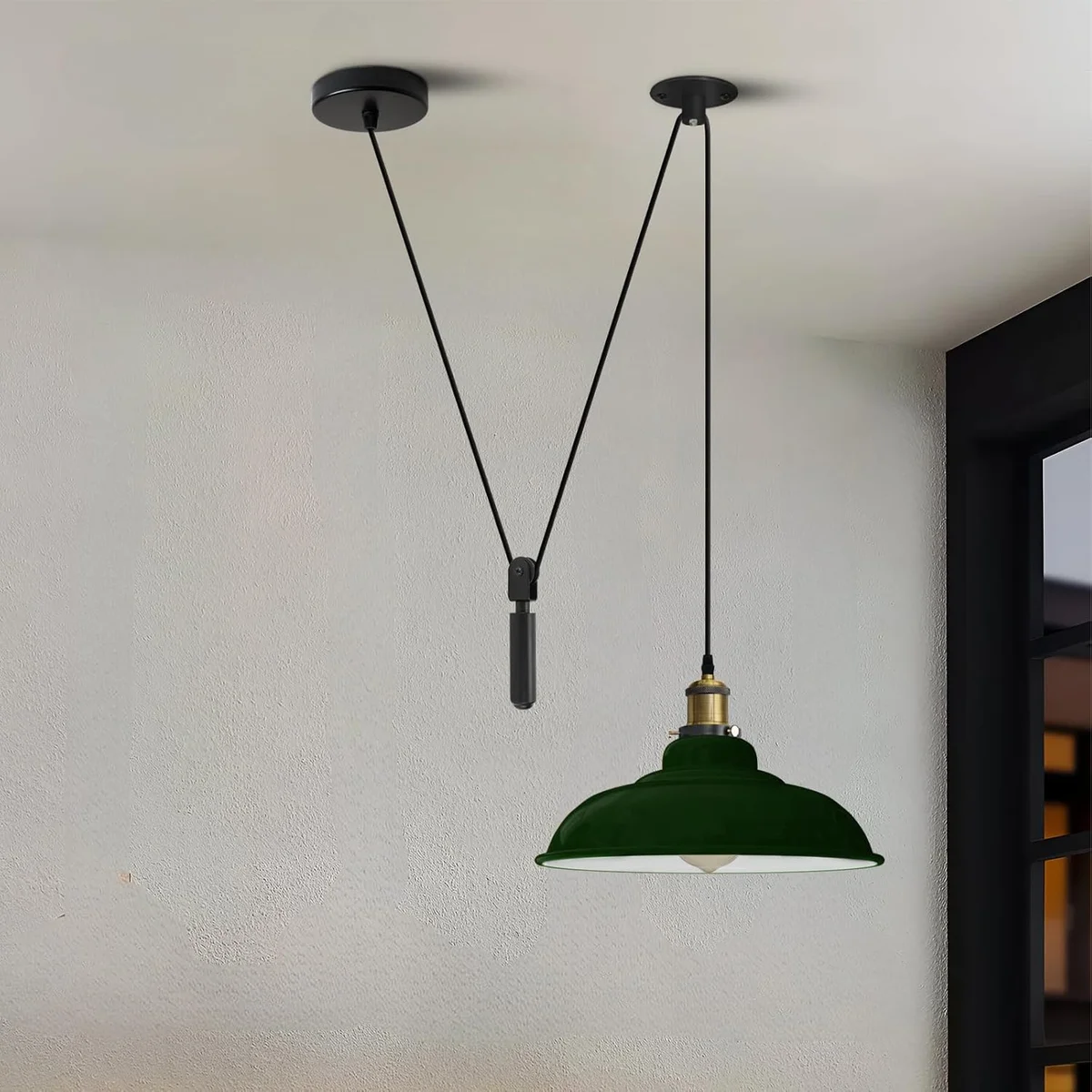 Green vintage industrial adjustable pendant light with metal barn-style shade and pulley system hanging from ceiling