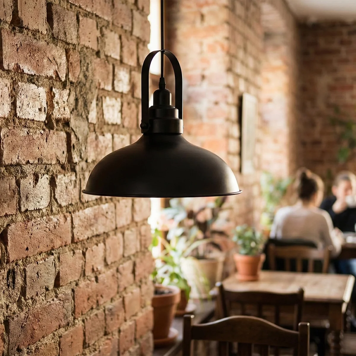 Painted black pendant light with metal shade hanging from ceiling, modern vintage style for living room or bedroom lighting