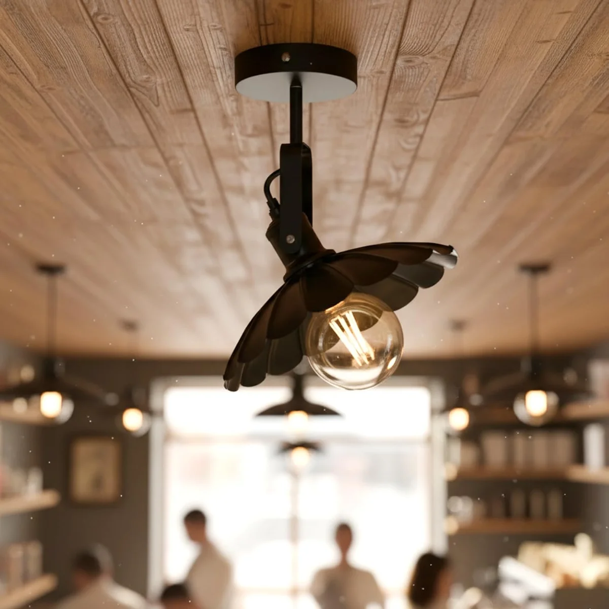 Matte black industrial swivel ceiling lamp with adjustable curved metal shade mounted on white ceiling