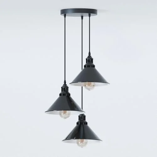 Black industrial pendant light with three adjustable metal shades hanging over a kitchen island, vintage style