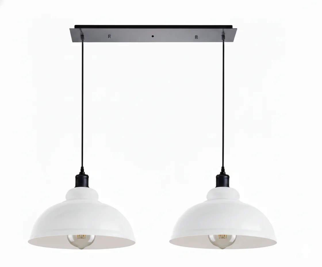 Two metal dome pendant lights with adjustable cords hanging over a kitchen island, satin nickel finish visible