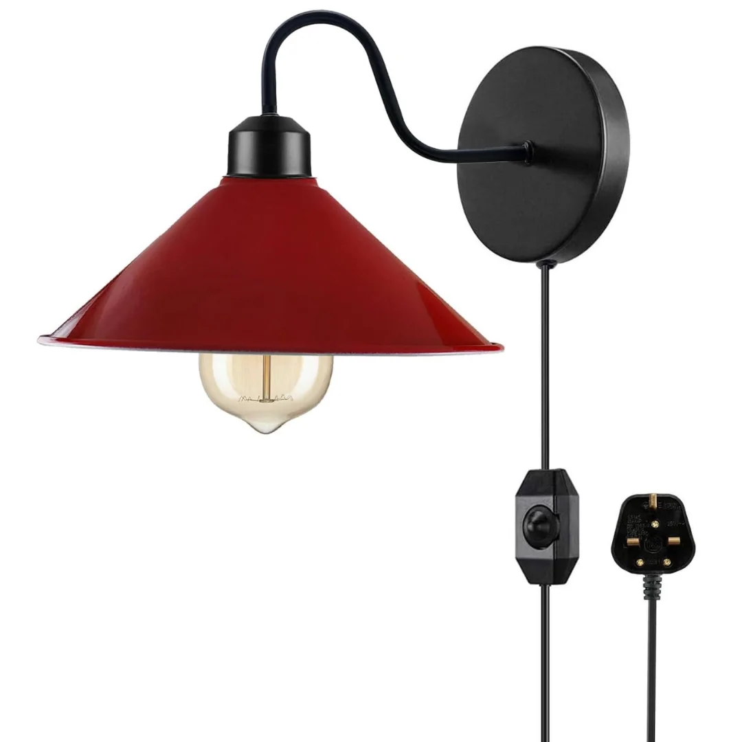 Red metal plug in lamp with E27 bulb base and fabric cord dimmer switch mounted on white wall