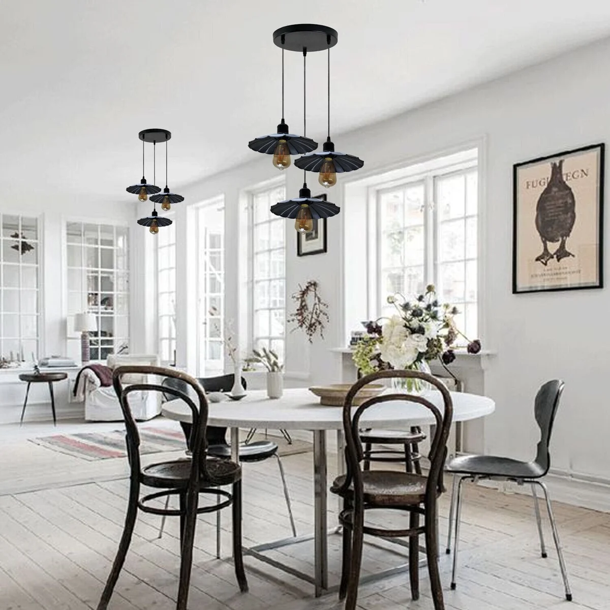 Black vintage industrial pendant light with three metal shades hanging from PVC cables against a white background
