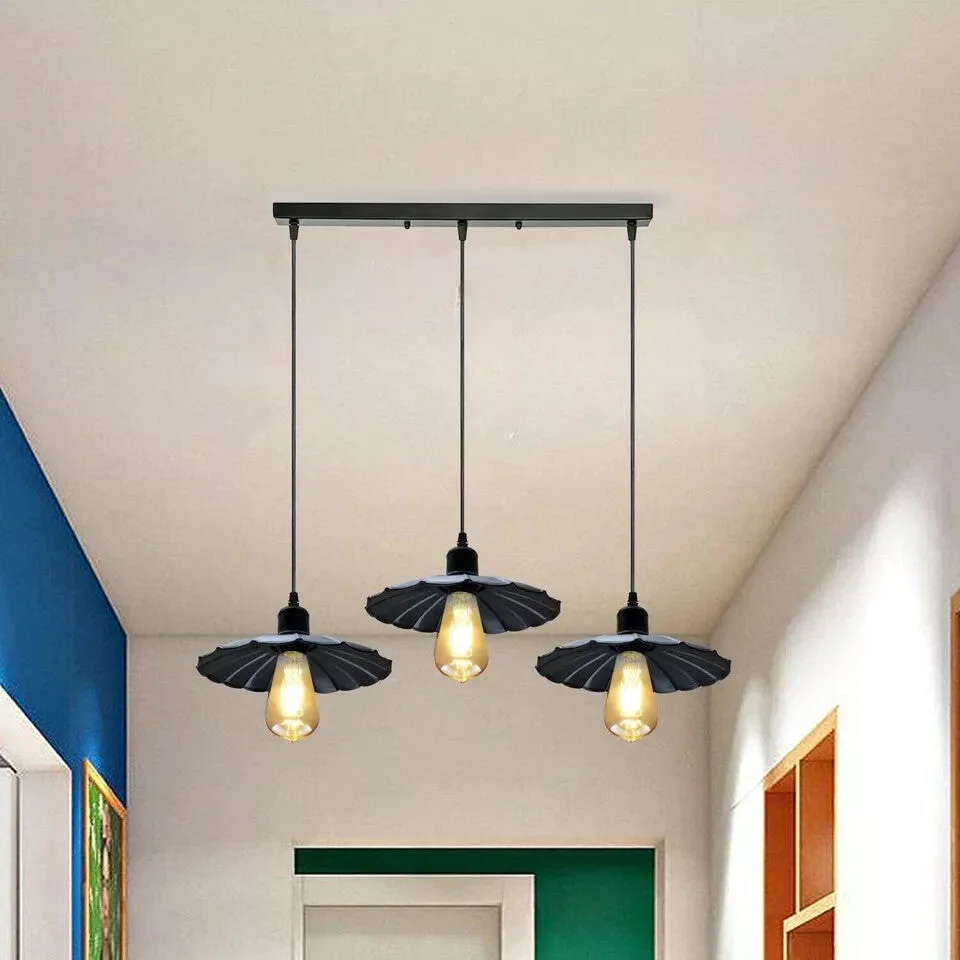Black vintage industrial pendant light with three metal shades hanging from 95cm PVC cables against white background