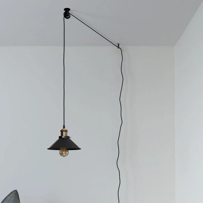 Black adjustable pendant light pulley wheel system with metal construction and mounting hardware for ceiling or wall installation