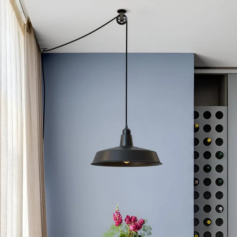 Black metal pulley for lights showing smooth wheel and mounting bracket with screws for adjustable pendant lamp height