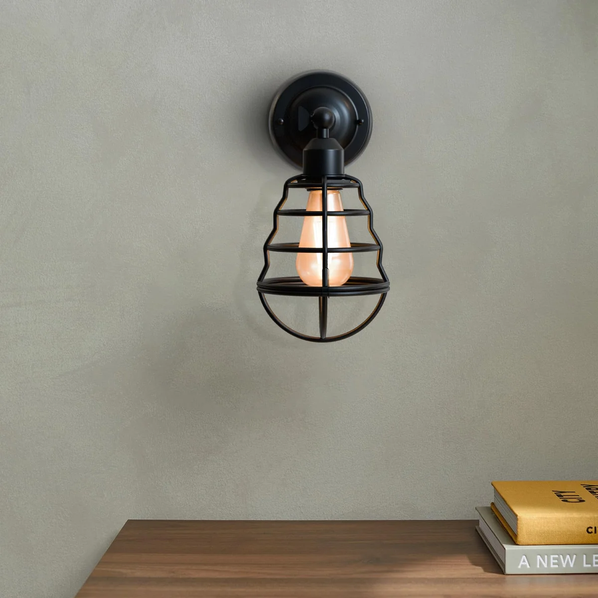 Adjustable industrial wall sconce with metal cage and balloon-shaped vintage design mounted on a white wall