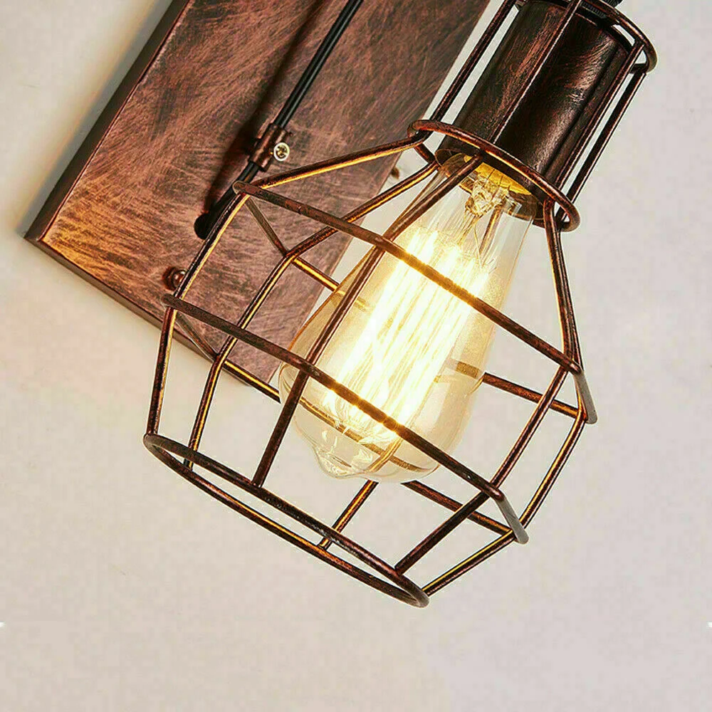 Brushed copper industrial E27 wall light with decorative pulley wheel and metal cage shade, hanging from an adjustable cable.