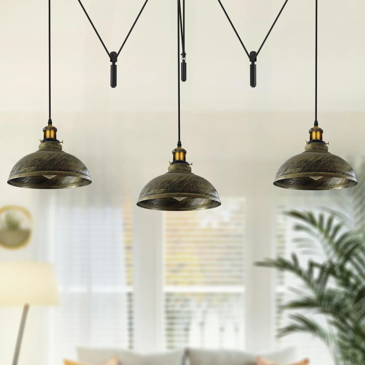 Vintage ceiling light with three adjustable metal shades hanging from a central ceiling rose in industrial style