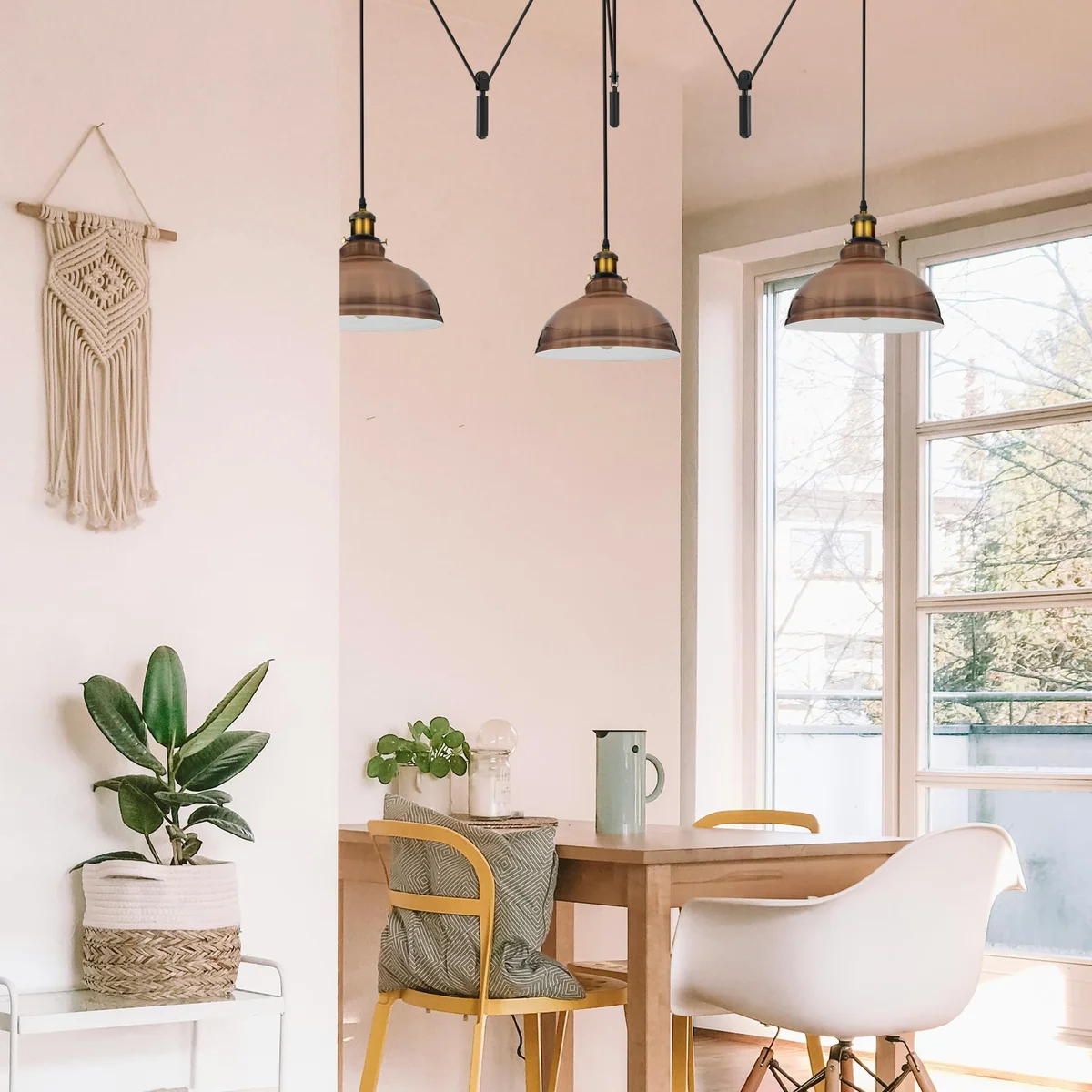 Industrial pendant light with three adjustable metal shades in vintage spider design hanging from ceiling