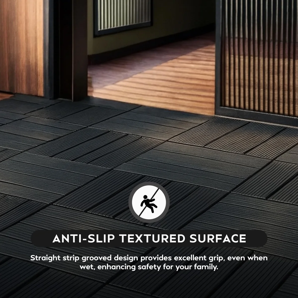 Interlocking anti‑slip decking tiles, dark grey square plastic panels arranged on a patio surface.