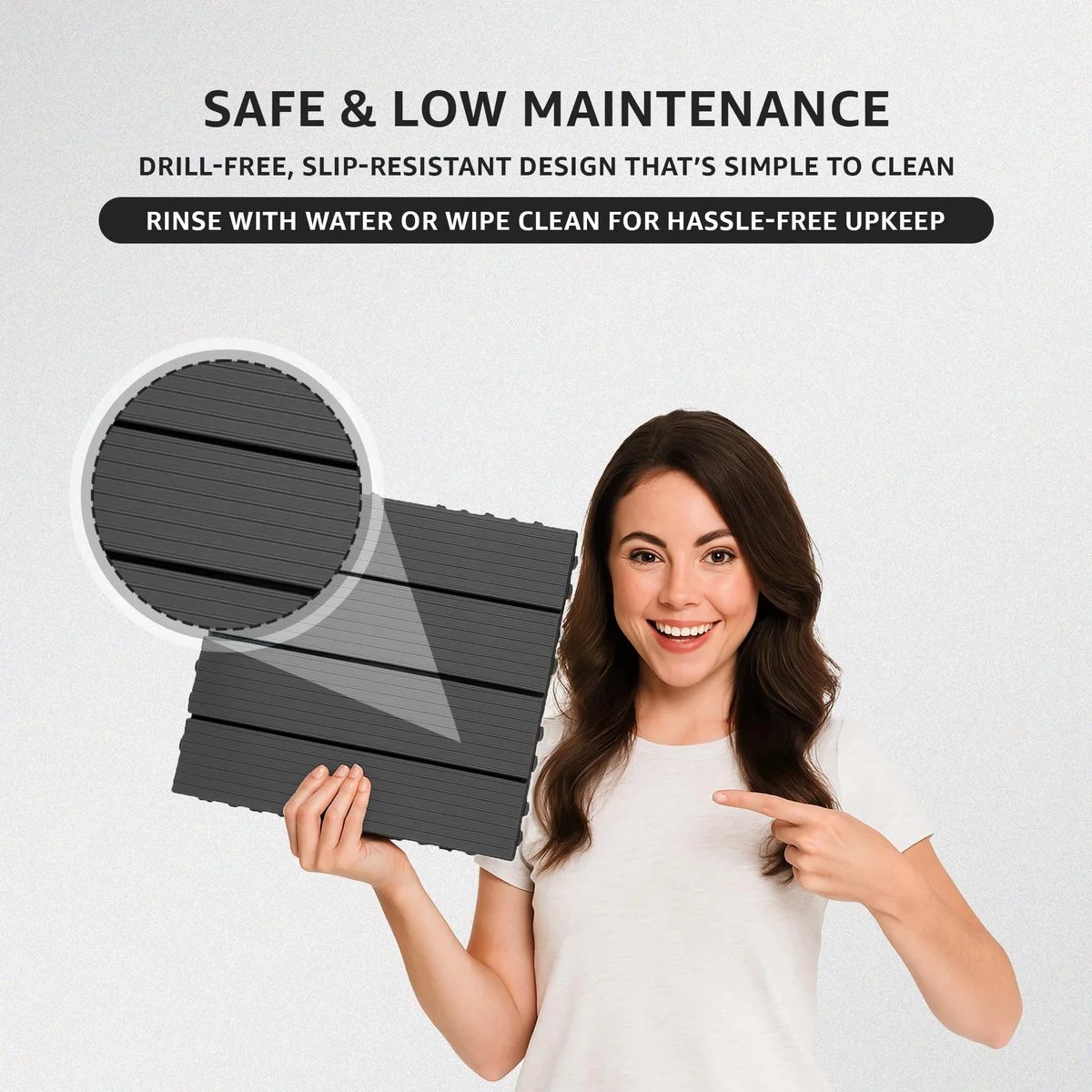 Four interlocking anthracite anti slip outdoor tiles with 4-slat pattern installed on a wooden patio floor