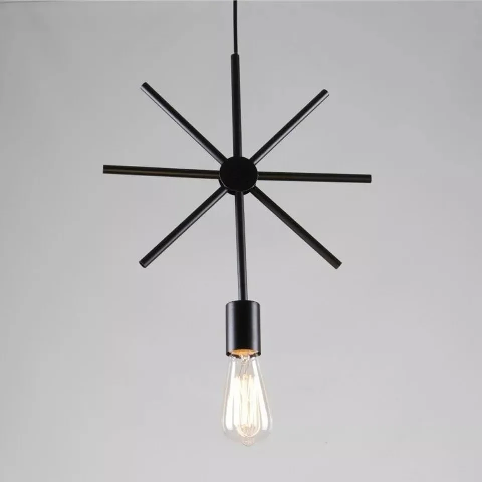Black vintage ceiling pendant with wrought iron frame hanging above a wooden dining table in a modern kitchen setting