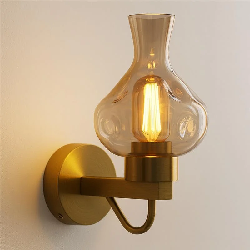 Mid-century modern wall sconce featuring an antique brass wall light with amber glass shade.