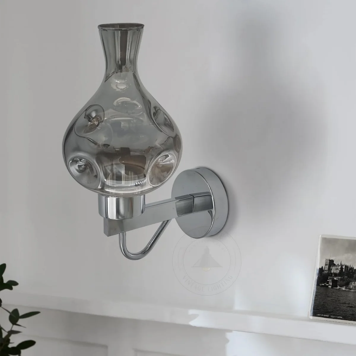 Mid century wall sconce in antique brass with amber glass shade, mounted on wall, vintage style