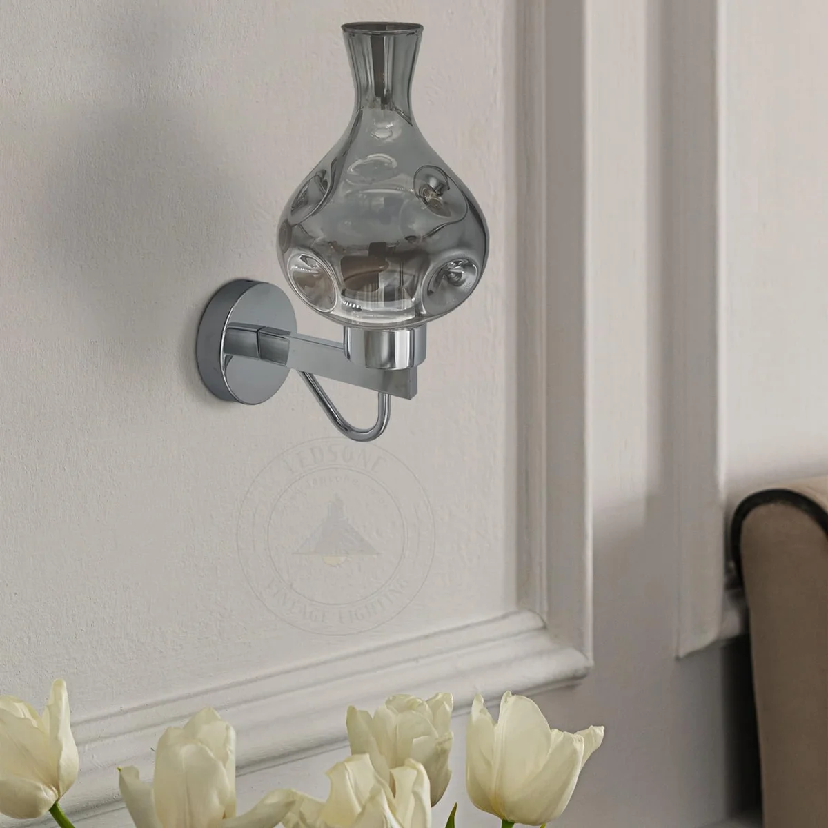 Mid century wall sconce with antique brass frame and amber glass shade, mounted on an interior wall.