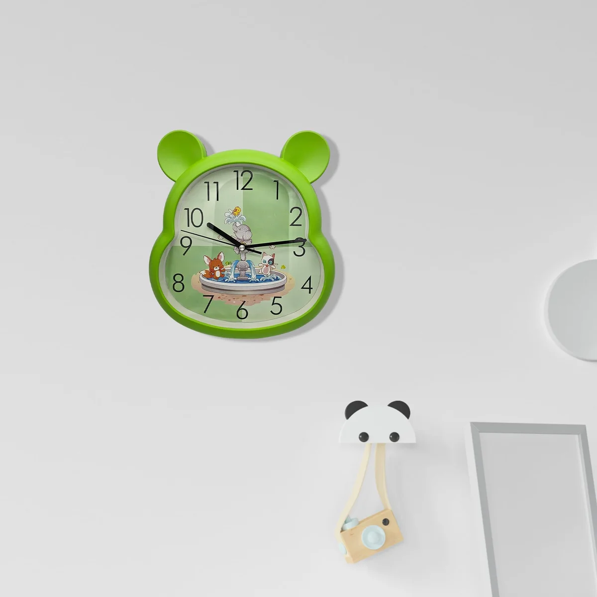 Colourful kids clock with modern design, plastic frame, battery powered, measuring 31cm tall by 29cm wide, indoor use