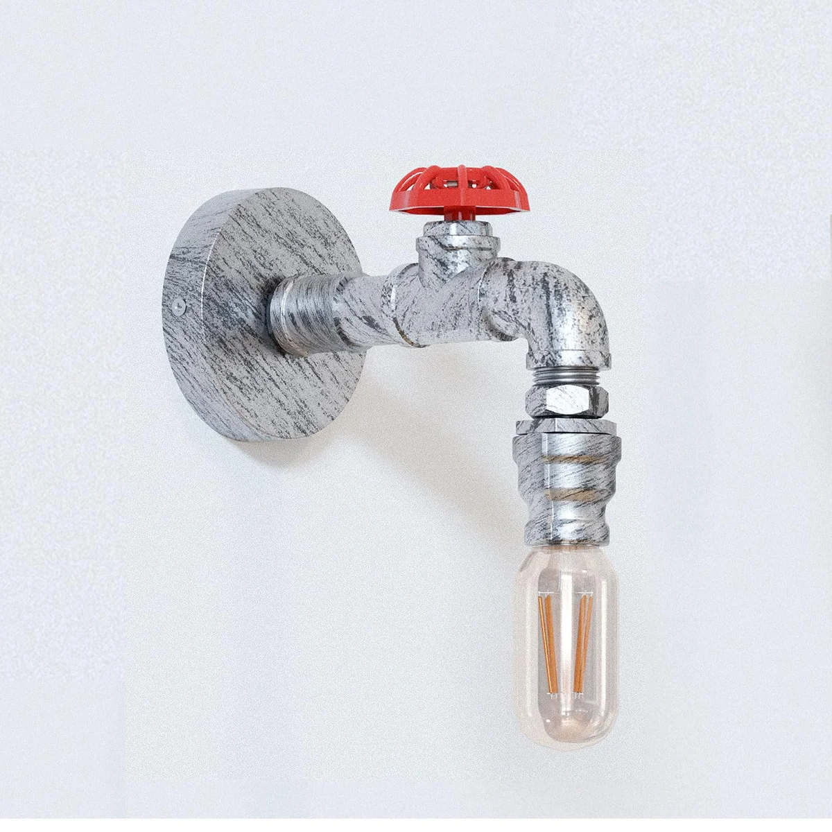 Industrial steampunk pipe hardwired wall sconce in black metal with vintage E27 bulb mounted on a wall back box