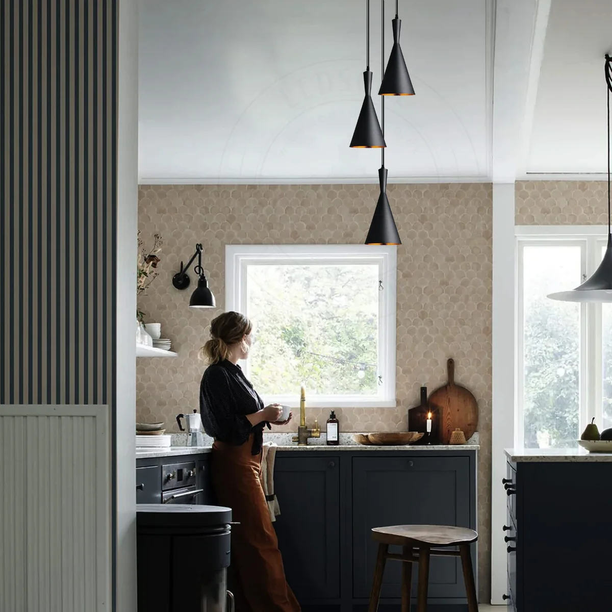 Modern pendant lamp with three metal shades in spray-painted finish and gold interior, hanging from ceiling fixture