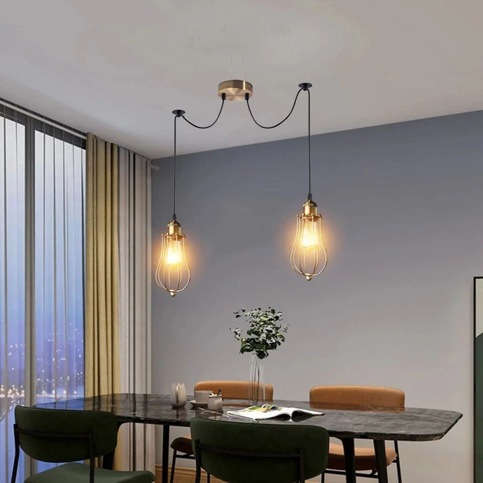 Industrial spider pendant in antique brass with tiered teardrop wire cages and adjustable cables hanging from ceiling