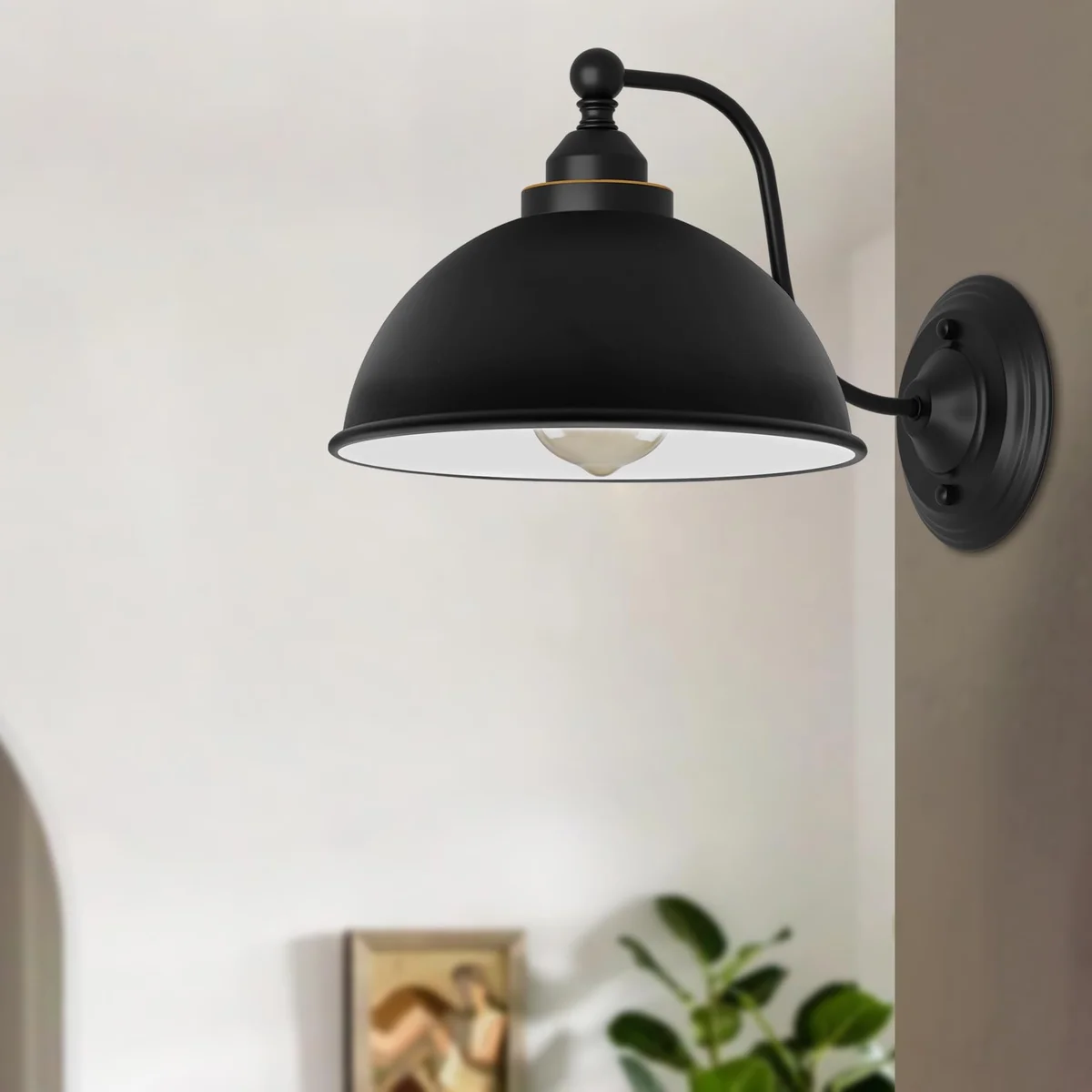 Vintage industrial wall light with curved swan neck arm and black metal dome shade mounted on a white wall