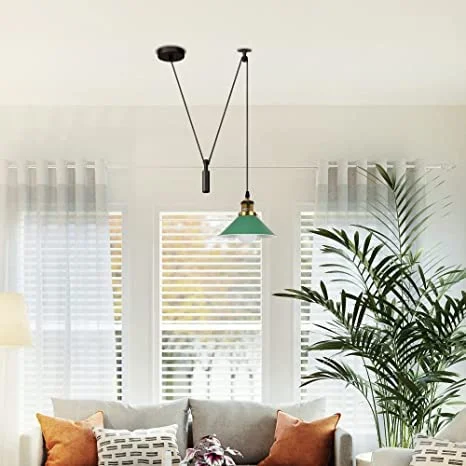 Black industrial pulley ceiling light fixture with metal parts and long cable, styled for modern interiors and offices