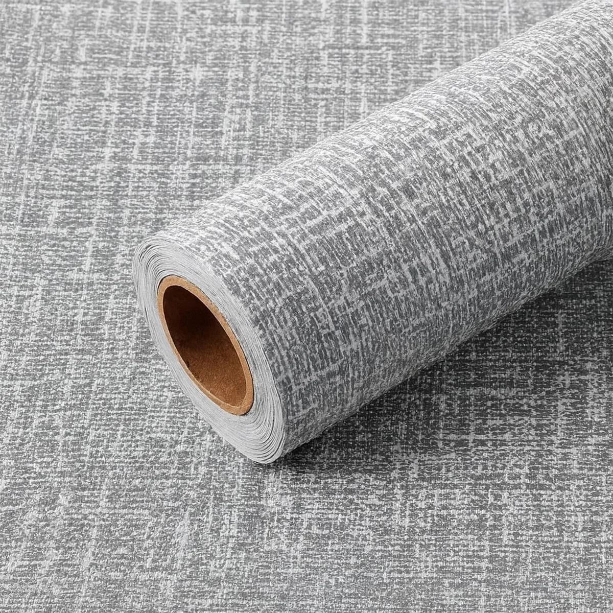 Roll of grey peel and stick wallpaper with a textured faux linen finish, measuring 50 cm by 280 cm