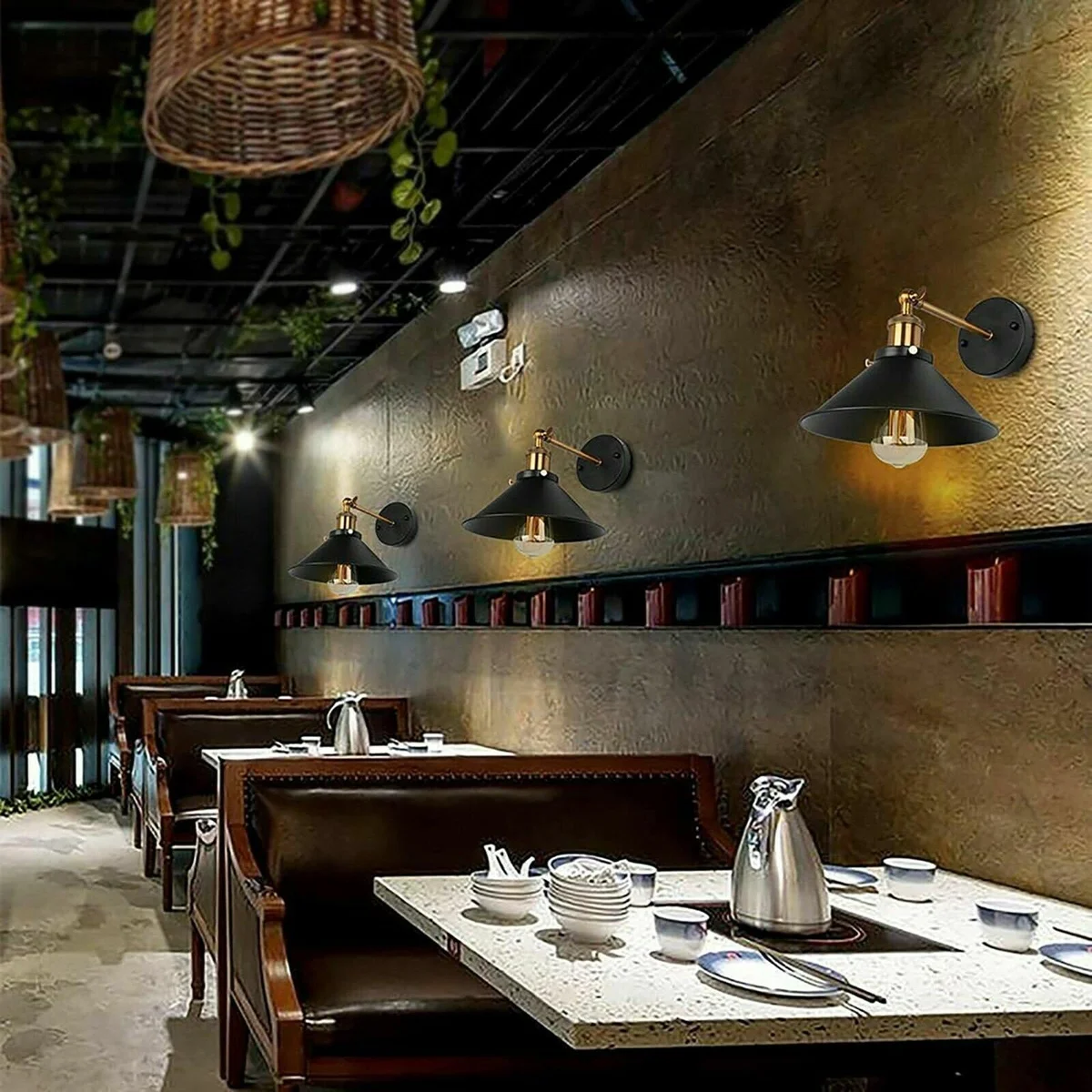 Two black industrial wall sconce LED light fixtures mounted side by side on a white wall