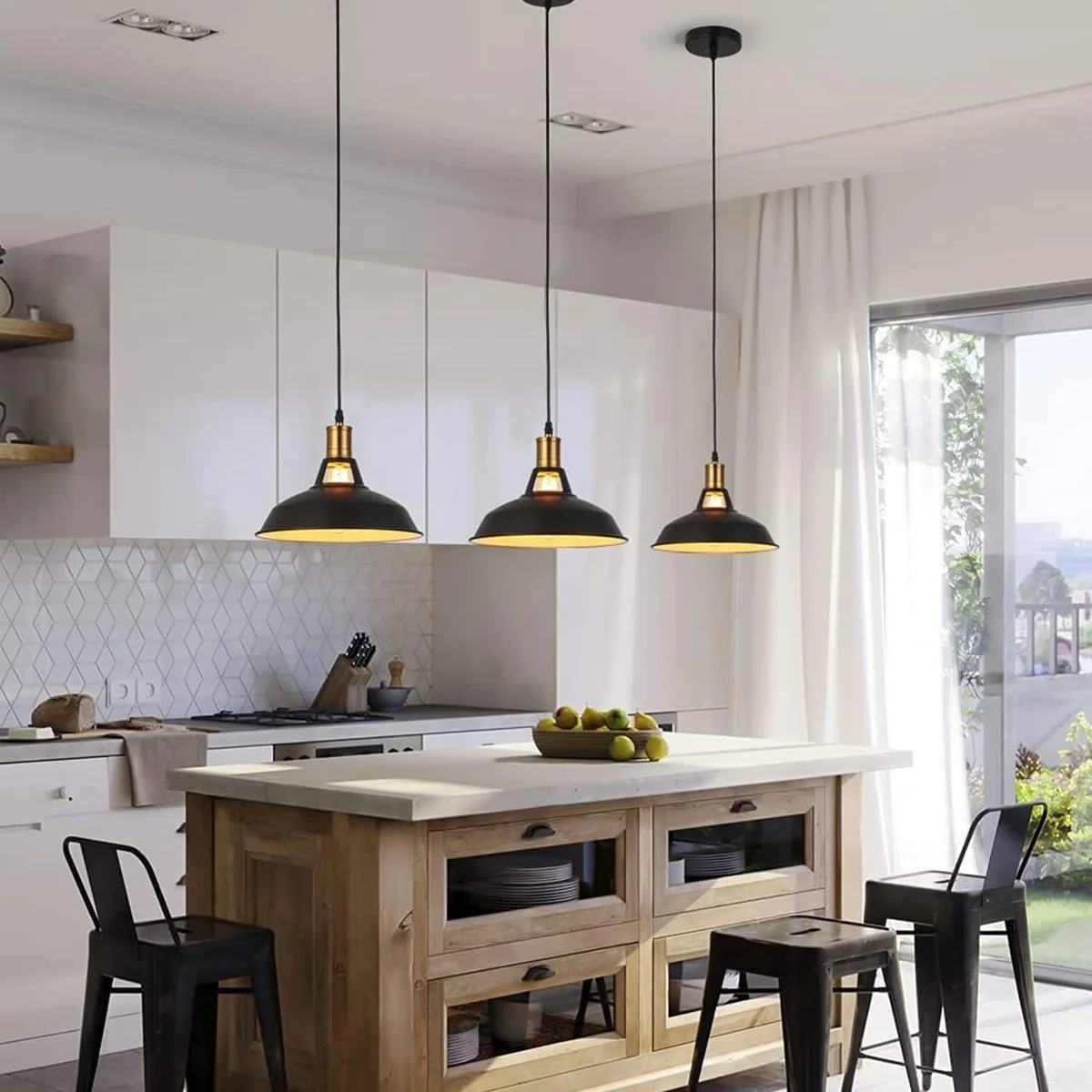Three black metal industrial pendant lights with dome shades hanging from adjustable cables against white background