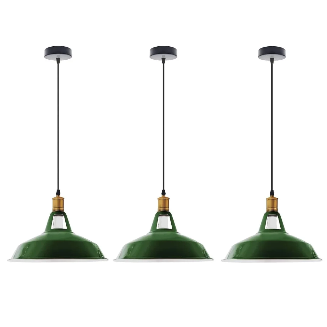 Three black metal industrial pendant lights with adjustable cables hanging over a wooden dining table in a modern kitchen