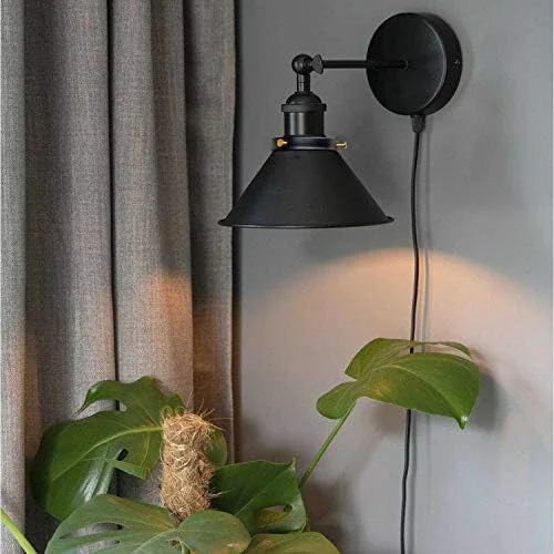 Adjustable black wall light with matte black metal cone shade and swivel arm, featuring in-line dimmer switch and plug-in cord