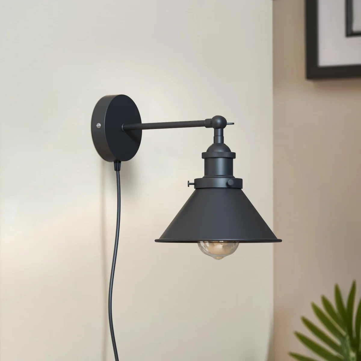 Matte black industrial dimmer switch wall light with adjustable cone shade and swivel arm mounted on a wall