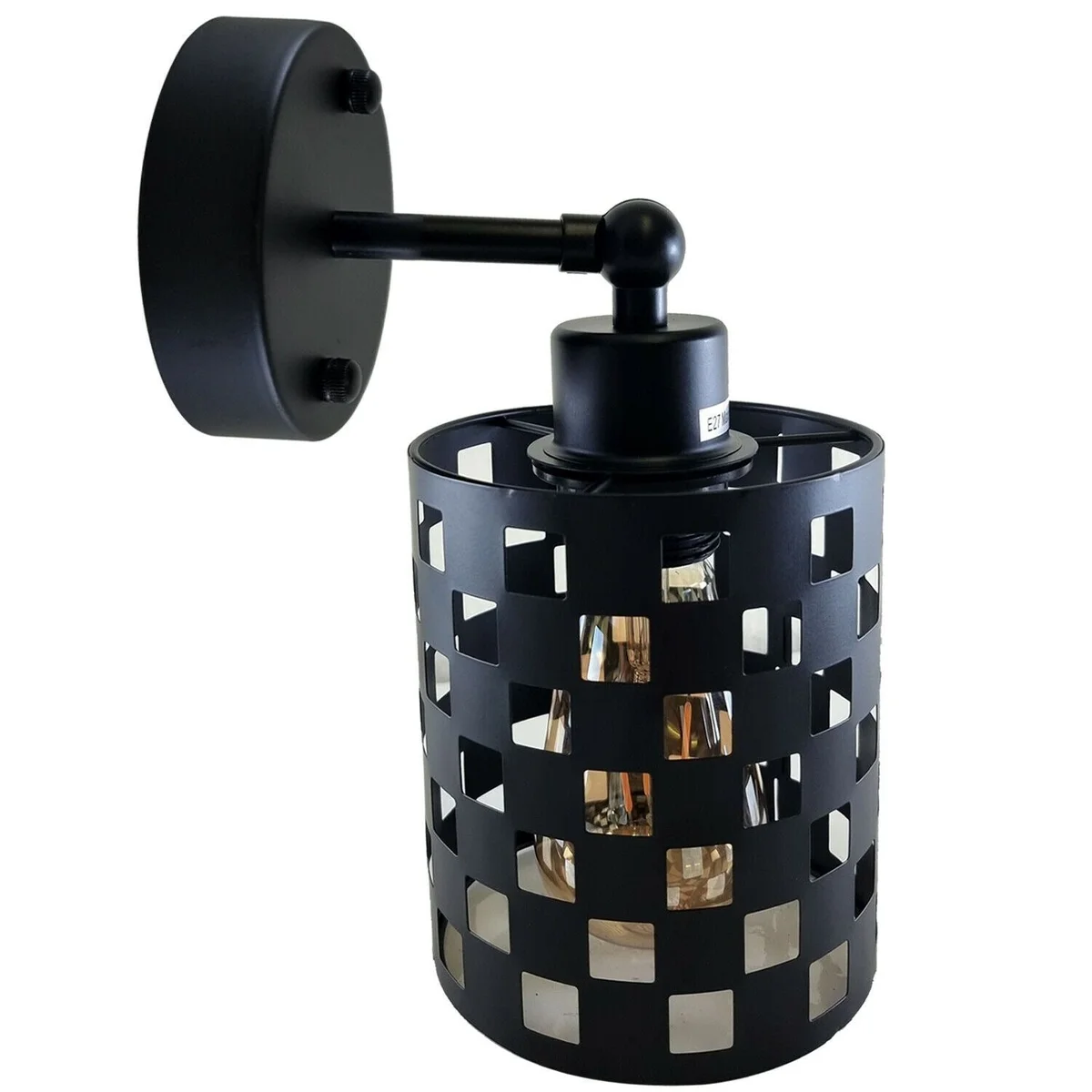 Black industrial adjustable wall light with cylindrical shade and metal arm mounted on white wall, angled downwards
