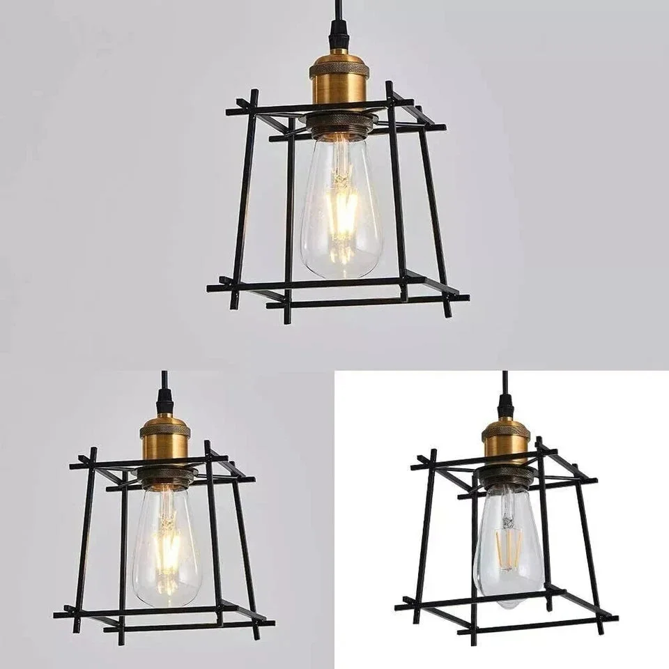 Matte black geometric cage kitchen pendant light with antique brass socket hanging over kitchen counter with plants nearby