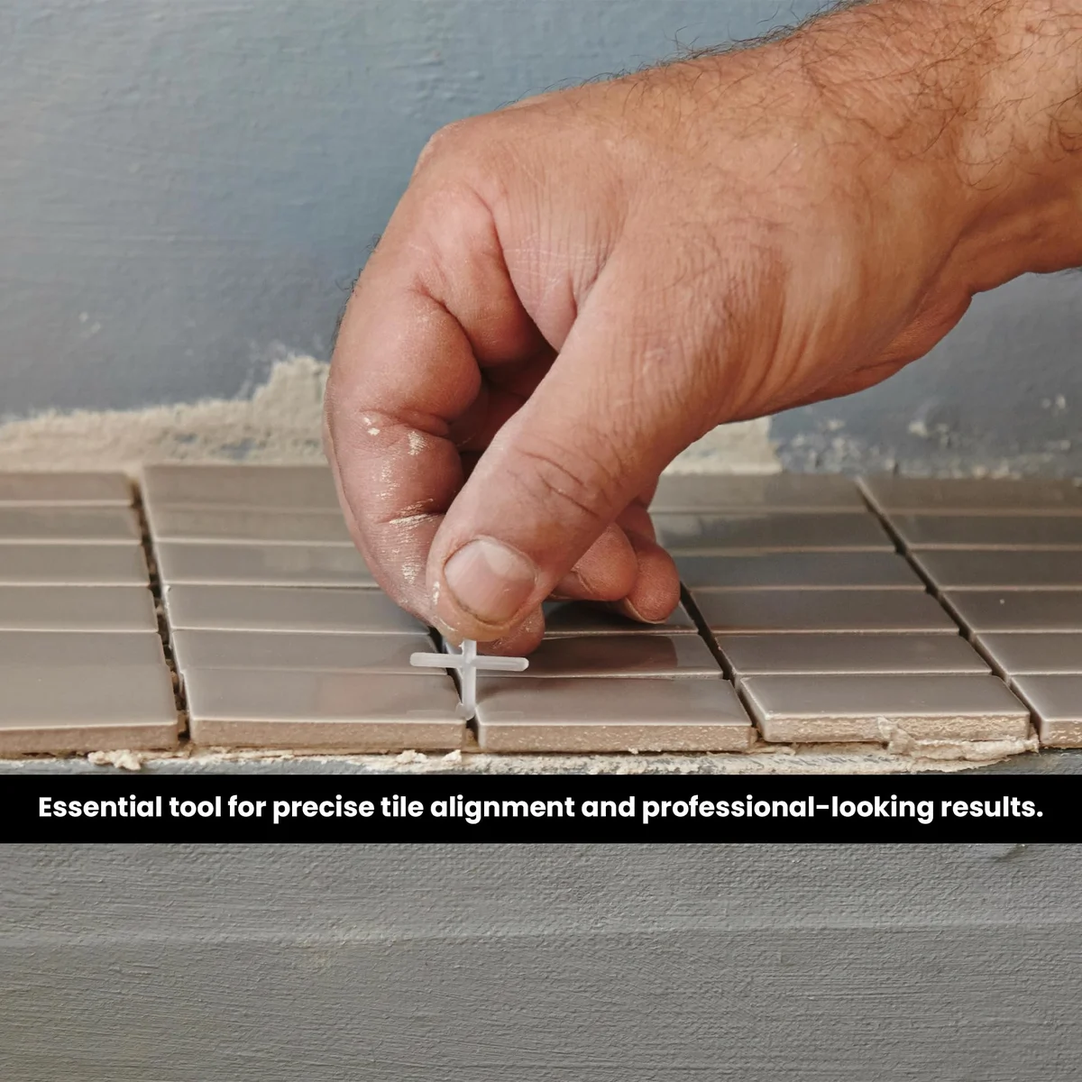 White plastic cross-shaped tile gap spacers arranged neatly on a plain background, showing their X-shape design