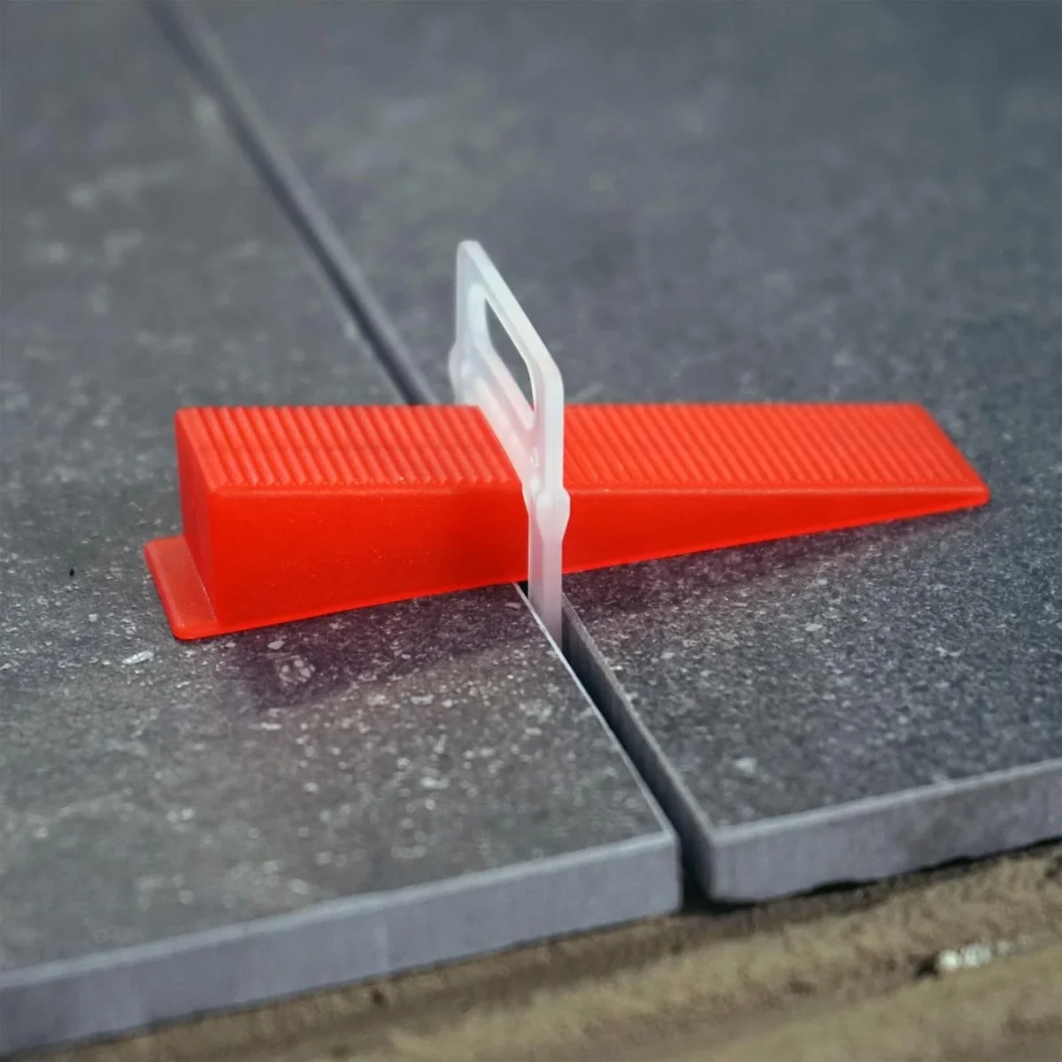 White x-shape tile spacers clips made from durable plastic, arranged to show their shape and size for tiling gaps