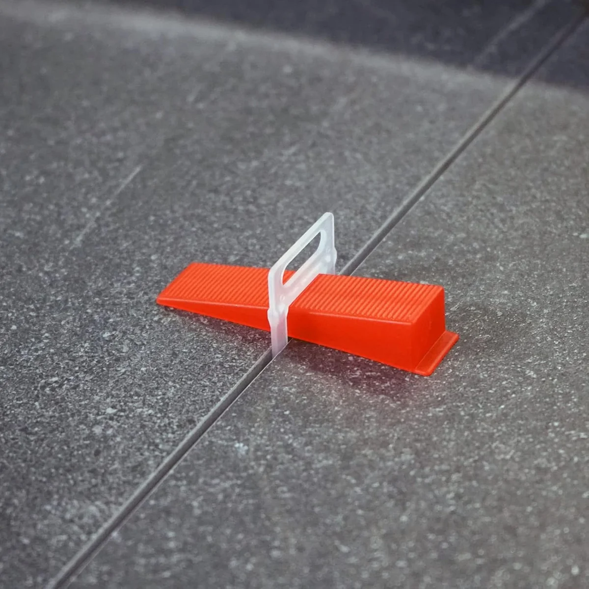 White X-shaped durable tile spacers clips made from tough plastic, shown in a neat arrangement on a white background