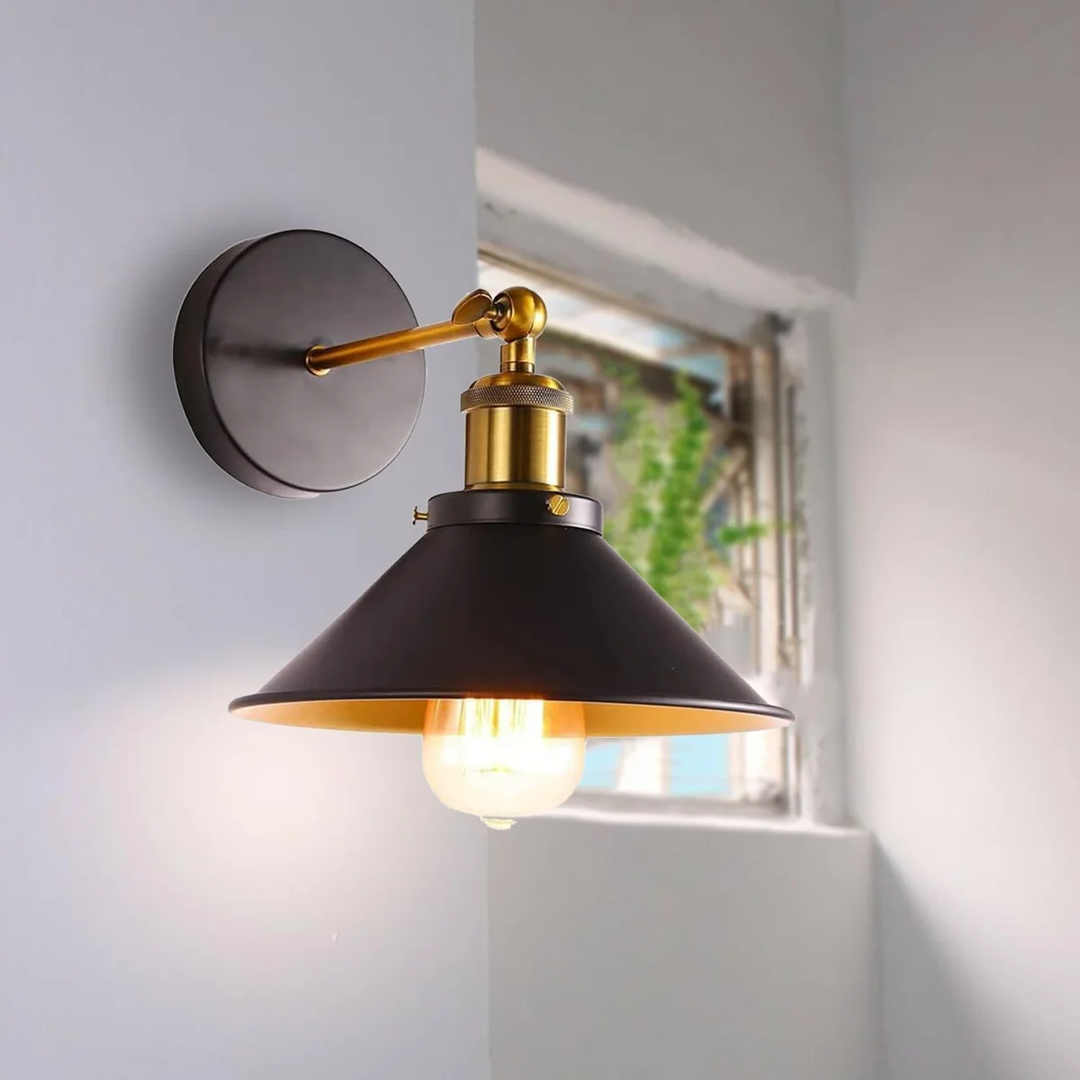 Pair of industrial metal wall lights with adjustable cone-shaped shades in vintage matte finish mounted on white wall