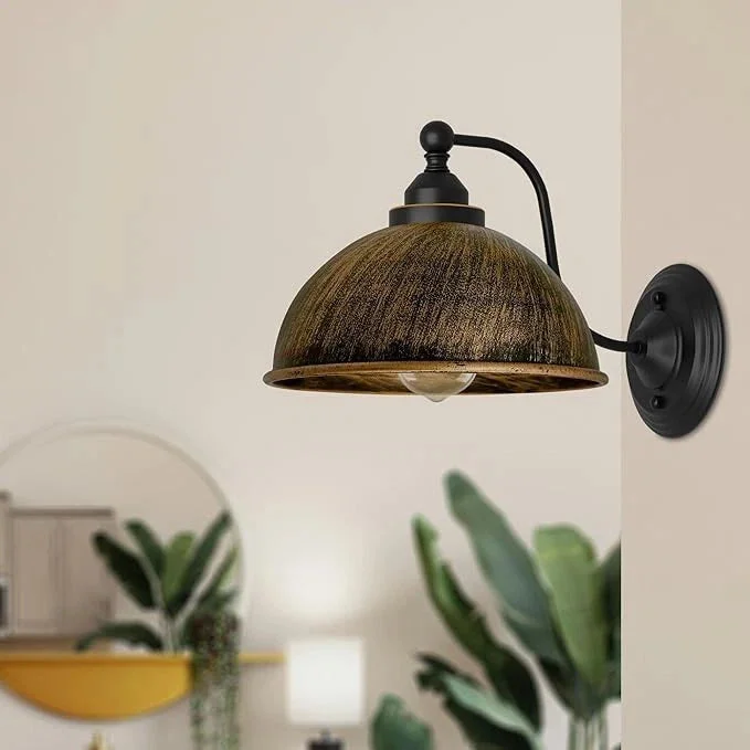 Brushed copper industrial wall sconce with dome shade, metal construction, and antique finish mounted on white wall