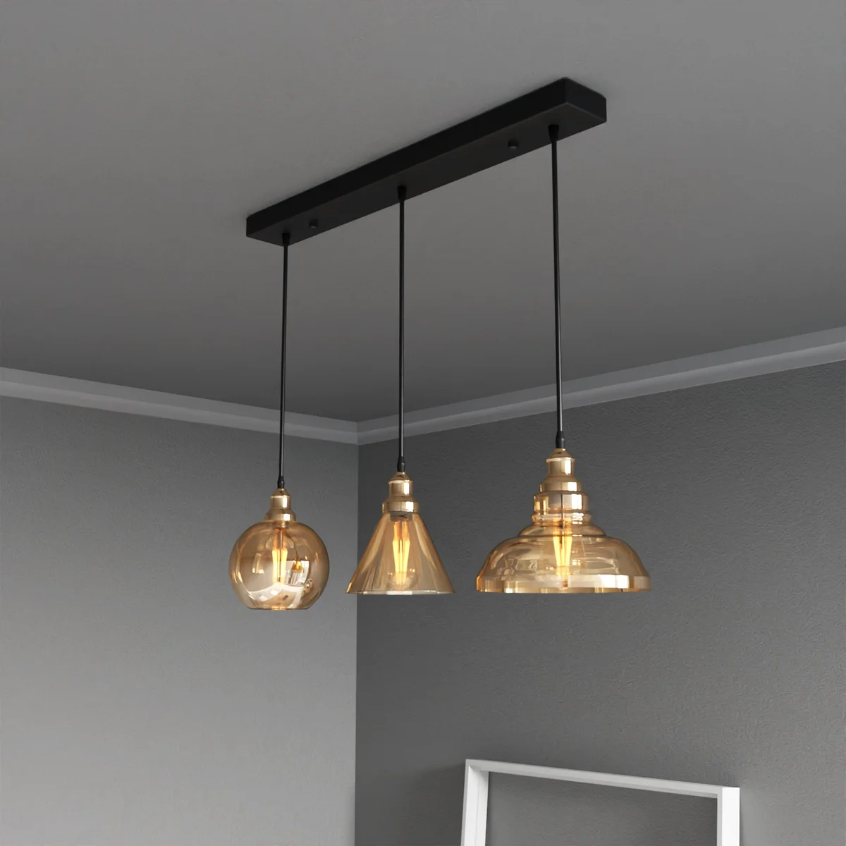 Metal frame pendant with three amber glass bowls and adjustable cables, industrial loft style